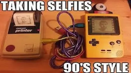 90s retro gaming taking selfies with a gameboy and printing them out on a game boy printer.