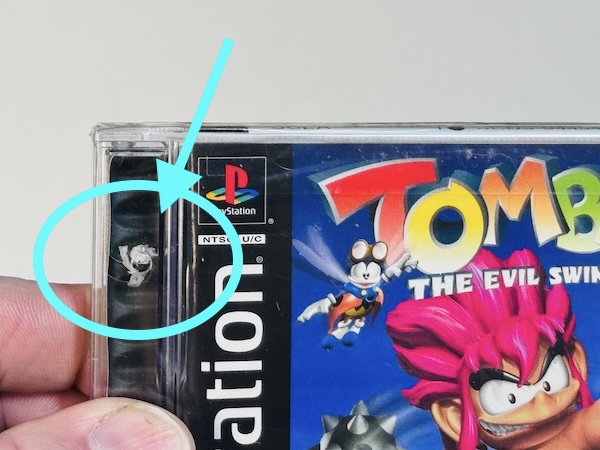 Example of brand new factory sealed game with a hole punch through it.