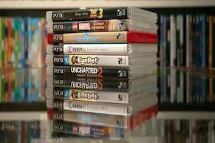 Sell PS3 games online – stack of PlayStation 3 game cases with artwork visible
