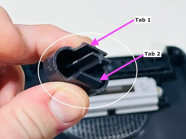 Step 2 - Push on the 2 tabs to remove the reset button from the Nintendo 64 Console