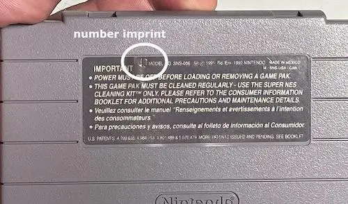 Close-up image of the back label of an SNES cartridge, showing the imprinted number codes such as '00' or '40,' which are indicators of authenticity in Super Nintendo games.